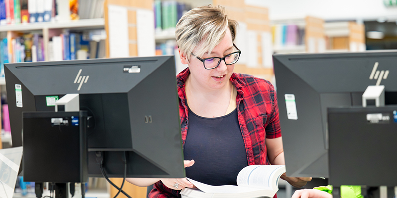 UHI Inverness student working in the campus library UHI Inverness student working in the campus library
