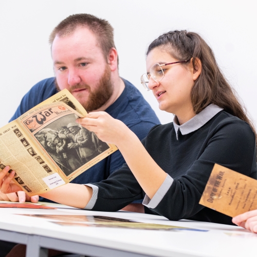 History student reading old newspaper