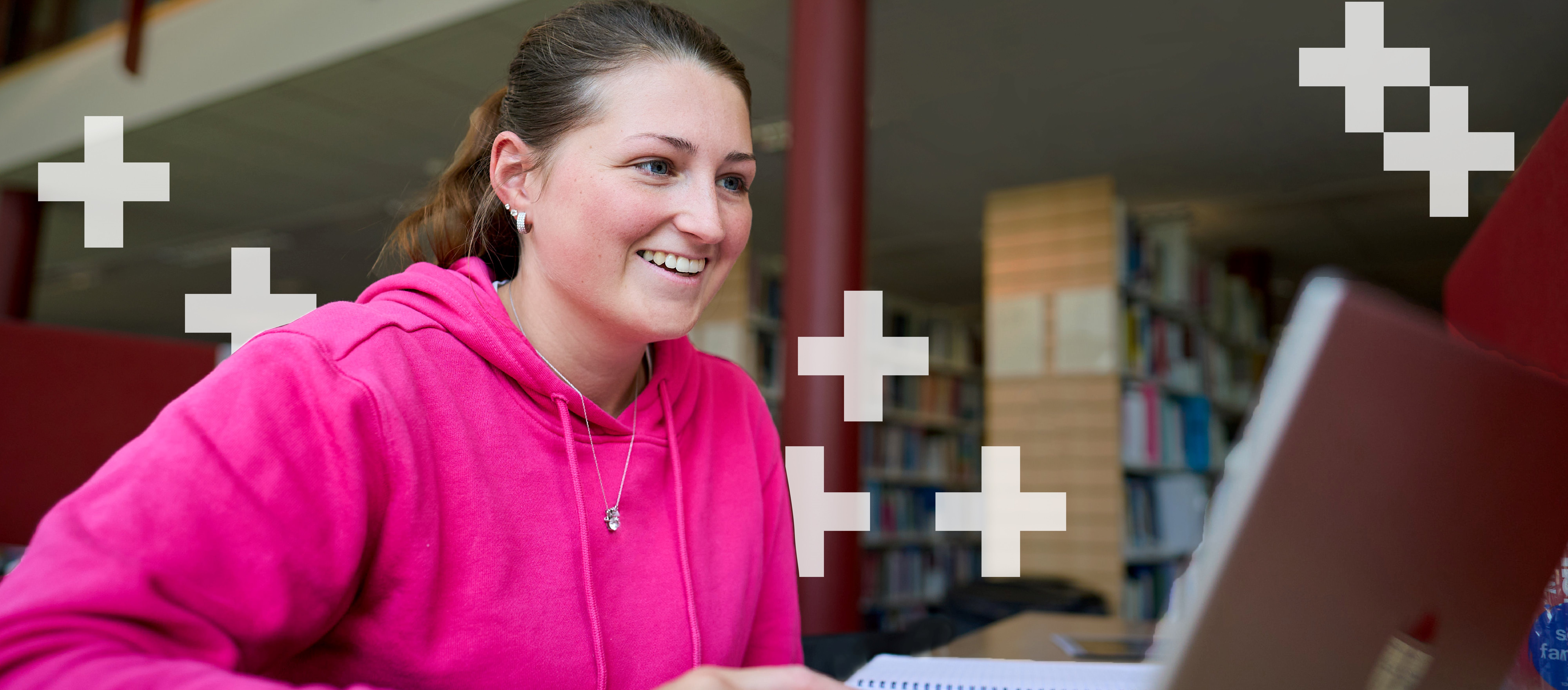 Girl in pink hoody on laptop