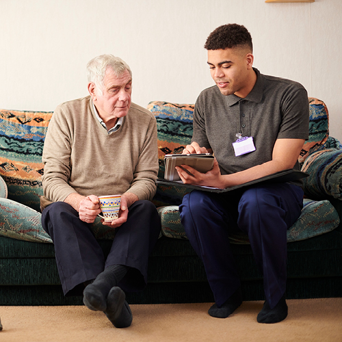 A medical professional talking to an elderly person