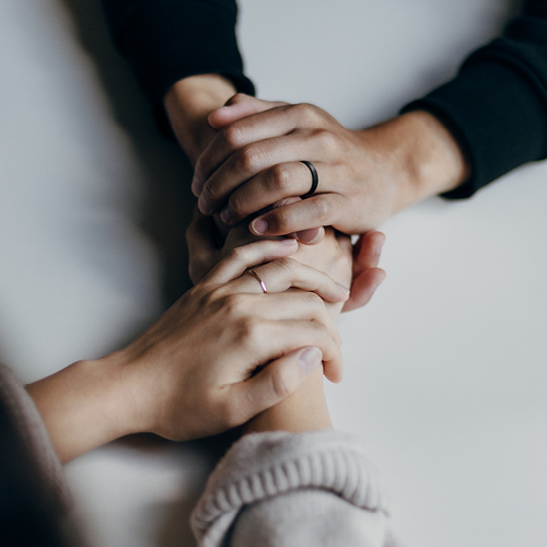 Four people holding hands