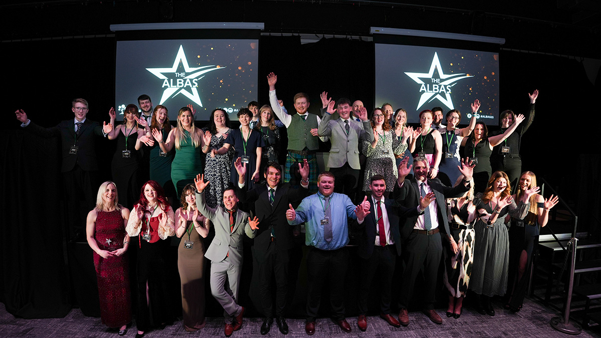 A large group of award winners standing on stage