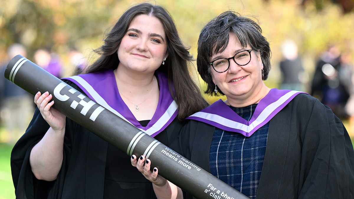Alix and Margaret Aburn in gowns holding giant scroll Alix and Margaret Aburn in gowns holding giant scroll