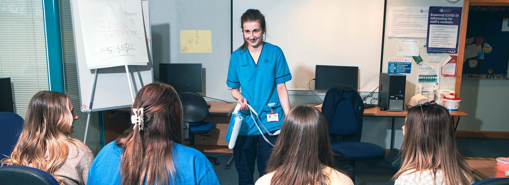 occupational therapist giving talk to care students