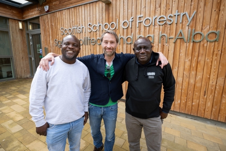 Left to right: Precious Munyanduki, Dr Euan Bowditch and Professor Peter Oluremi Adesoye, standing outside the Scottish School of Forestry
